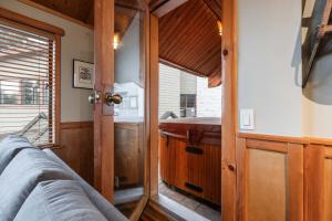 a bathroom with a sink and a bed in a room at Rainbow Lodge by Outpost Whistler in Whistler