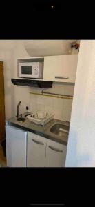 a kitchen with a sink and a microwave at Studio tout confort cité de la gastronomie (4) in Dijon