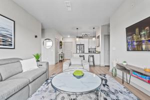 a living room with a couch and a table at Downtown St Pete 2 Bed Near Tropicana Field WIth Free Parking in St Petersburg