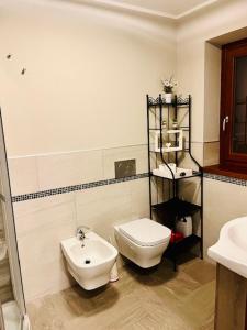a bathroom with a toilet and a sink at Incantevole Appartamento con Giardino - Free WiFi e Private Garage in Oulx