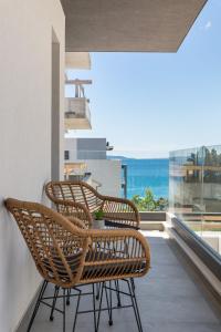 two chairs on a balcony with a view of the ocean at Apartment Karla in Split