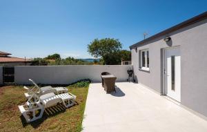 a patio with chairs and a table and a building at House Peroj in Peroj +5 photos