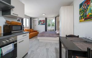 a kitchen with a living room with a couch at House Peroj in Peroj