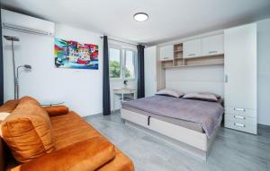 a bedroom with a bed and a couch at House Peroj in Peroj