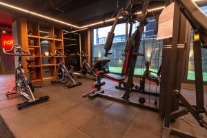 a gym with several tread machines in a room at Acogedor apartamento con piscina en Bogotá in Bogotá