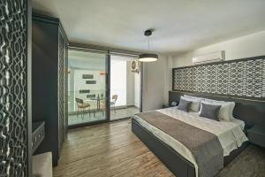 a bedroom with a large bed and a balcony at Villa Rio in Kalkan