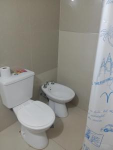 a bathroom with a white toilet and a sink at AlquiloenNeuquen in Neuquén