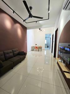 a living room with a couch and a flat screen tv at Air-home No 28 Simpang near Aulong Econsave, 3BR, 7pax, Netflix in Simpang