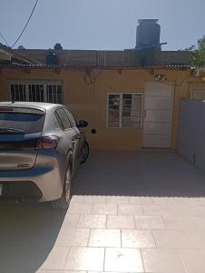 a car parked in a parking lot in front of a house at AlquiloenNeuquen in Neuquén