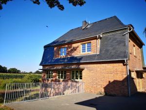 an old brick house with a black roof at Bahnhof Hohen Mistorf - Ferienwohnungen in Hohen Mistorf