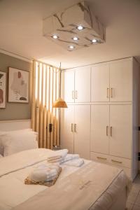 a bedroom with a bed with white cabinets at SeaView Luxury Suite in Alexandroupoli