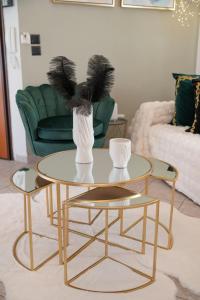 a table with two chairs and a vase on it at SeaView Luxury Suite in Alexandroupoli