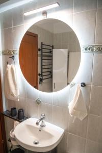 a bathroom with a sink and a mirror at SeaView Luxury Suite in Alexandroupoli