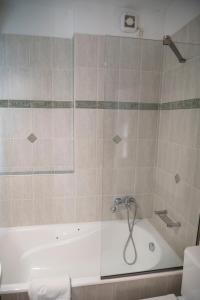 a shower in a bathroom with a bath tub at SeaView Luxury Suite in Alexandroupoli