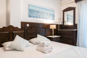 a bedroom with a bed with towels on it at Afrodite Hotel Apartments in Myrina