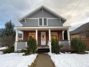 a house with snow in front of it at Chalet Au Bon Pain by Fernie Lodging Company in Fernie