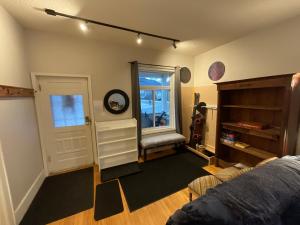 a room with a bed and a window and a door at Chalet Au Bon Pain by Fernie Lodging Company in Fernie