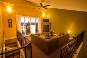 a living room with a couch and a ceiling fan at Crooked Tree Guest Suites in Penticton