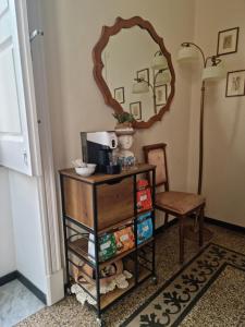 a room with a table with a mirror and a chair at B& B Cà de Andreas in Catania