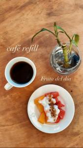 a table with a plate of food and a cup of coffee at Aqua Suites in Oaxaca City