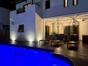 a house with a swimming pool and a living room at Casa del Mar - Piscina y Jacuzzi Privado in Costa Teguise