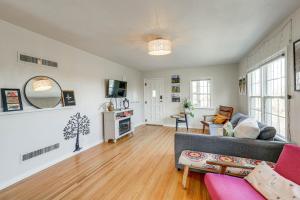 a living room with a couch and a table at Central Rapid City Home with Sunroom and Fireplace! in Rapid City