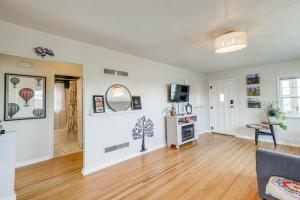 an empty living room with a couch and a tv at Central Rapid City Home with Sunroom and Fireplace! in Rapid City +17 photos