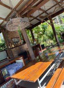 a wooden table and chairs under a roof at Chiltern Lodge Country Retreat in Old Bar