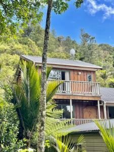 a large house with a balcony on the side of it at Annabells B&B in Whitianga