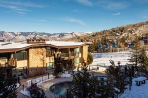 a resort with a swimming pool in the snow at Shadowbrook 505 in Snowmass Village