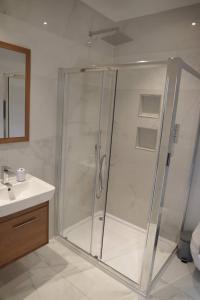 a shower with a glass door in a bathroom at Bridge House Farm in Weeton