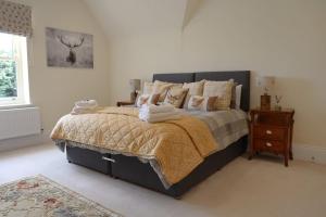 a bedroom with a large bed and a night stand at Bridge House Farm in Weeton