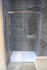 a shower with a glass door in a bathroom at Bridge House Farm in Weeton