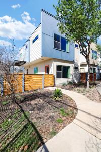 a house with a fence in front of it at Urban - A Birdy Vacation Rental in San Antonio