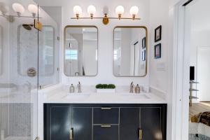 a bathroom with a sink and two mirrors at Urban - A Birdy Vacation Rental in San Antonio +42 photos