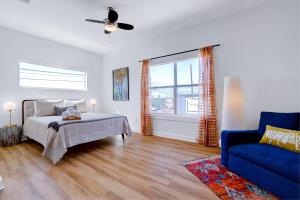 a bedroom with a bed and a blue couch at Urban - A Birdy Vacation Rental in San Antonio