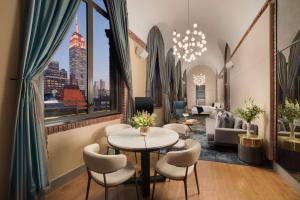 a hotel lobby with a table and chairs and a view of the city at NH Collection New York Madison Avenue in New York