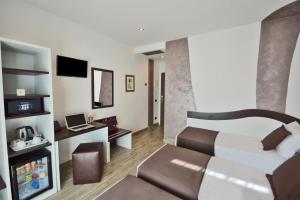 a hotel room with a bed and a television at Hotel Luxor Florence in Florence