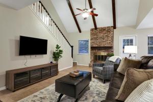 a living room with a flat screen tv and a fireplace at Wanderlust - A Birdy Vacation Rental in San Antonio