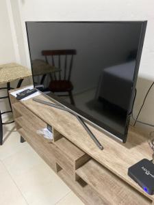 a flat screen tv sitting on top of a wooden table at Apartamento 01 Le Sorelle in Rosário do Sul
