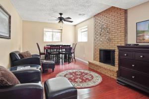 a living room with a fireplace and a dining room at Overland Park ( I 35, Hwy. 69, and 87 th St. ) in Overland Park
