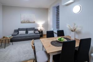 a living room with a table and a couch at Riga Embassy center Apartment with parking in Rīga
