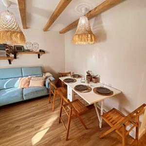 a living room with a table and a blue couch at El Hogarin de Veronica in Gijón