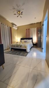 a bedroom with a bed and a ceiling fan at The shores in Montego Bay