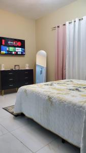 a bedroom with a large bed and a flat screen tv at The shores in Montego Bay