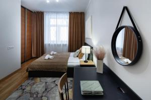 a hotel room with a bed and a mirror at Riga Embassy center Apartment with parking in Rīga