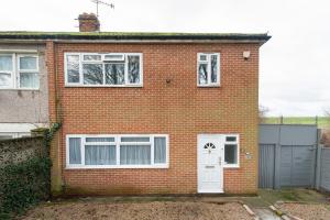 a brick house with a white door and windows at Chingford charm great for families and contractors in Ponders End