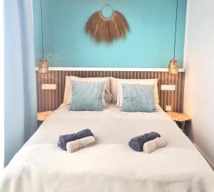 a bedroom with a large bed with two pillows on it at Luxury Penthouse Valentin with jacuzzi in Corralejo