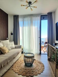 a living room with a couch and a table at Luxury Penthouse Valentin with jacuzzi in Corralejo