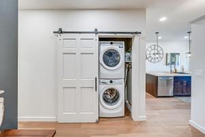 a washer and dryer in a room with a door at Stellar Craig Apartment - Walk to Restaurants! in Craig